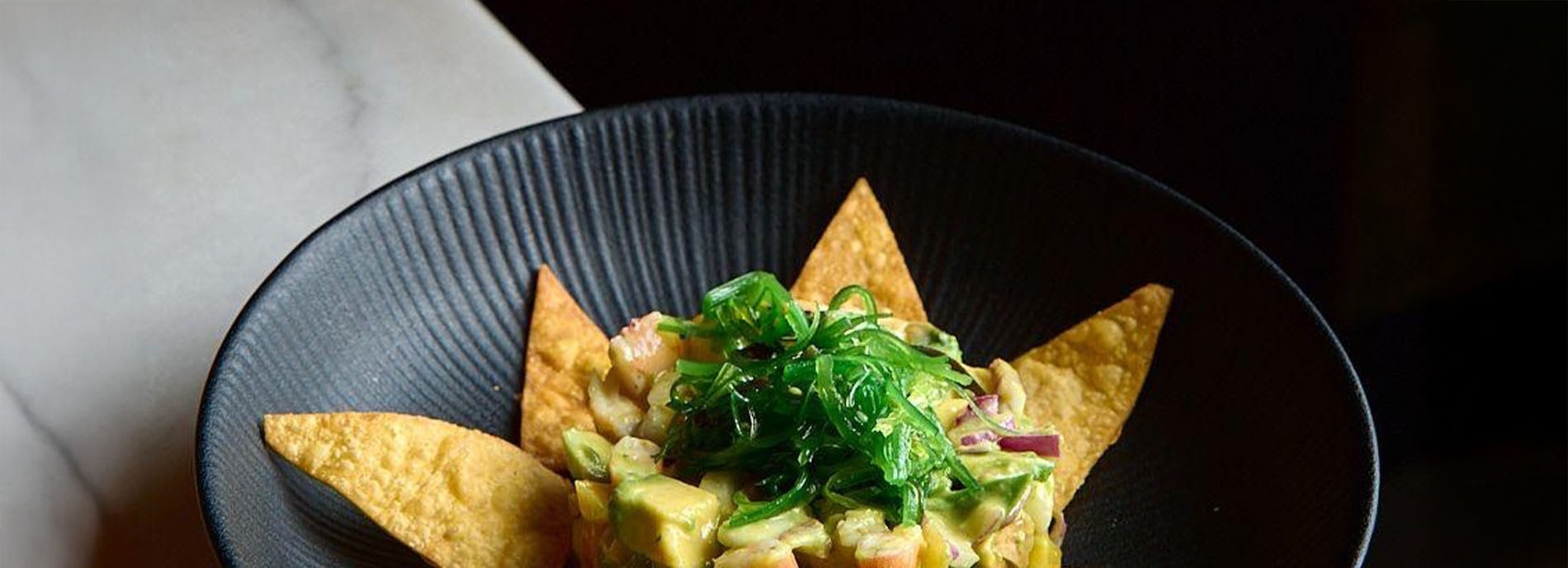 a hotel room with a pineapple on the bed