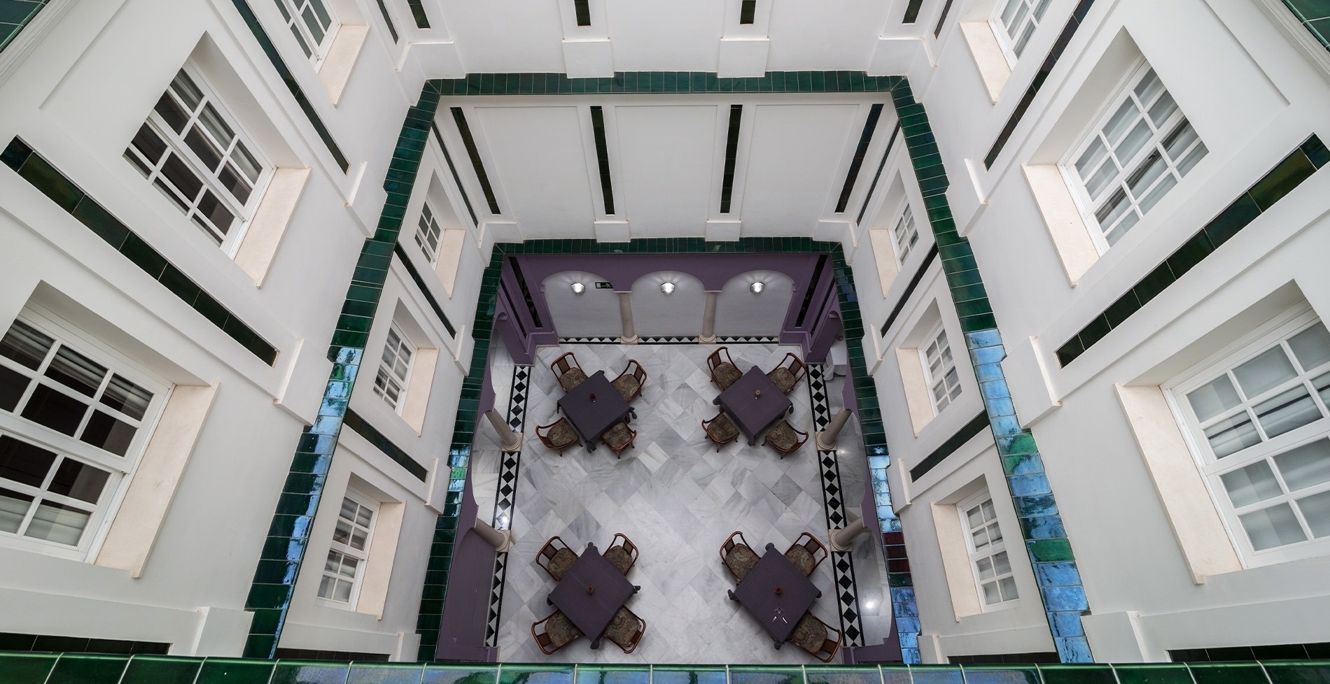 looking up into a building with tables and chairs