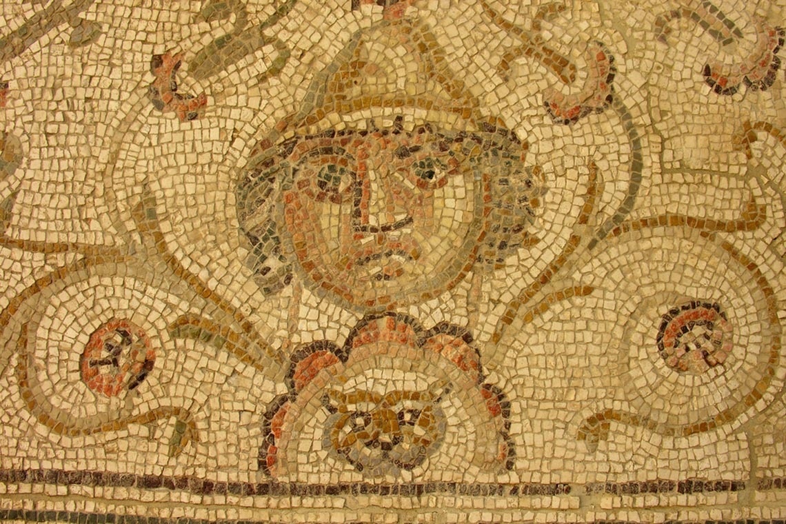 un primer plano de un mosaico con una cara en el centro