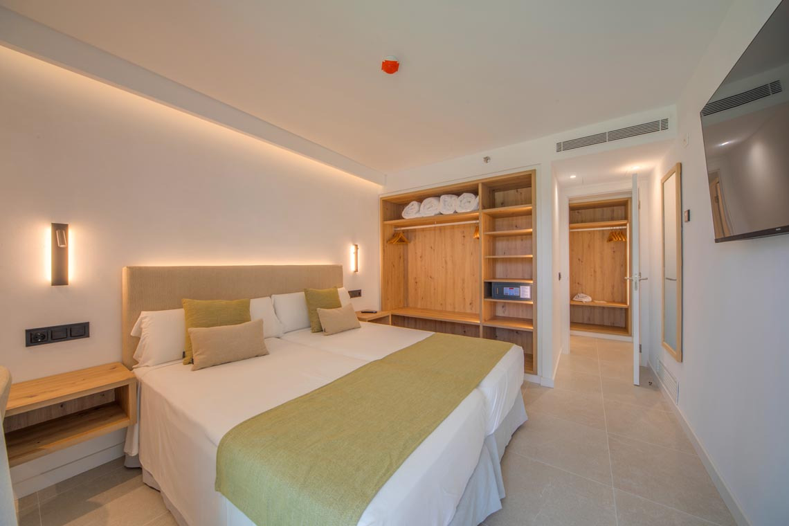 Habitación doble con armario y TV, perfecta para tu Playa Esperanza Resort.