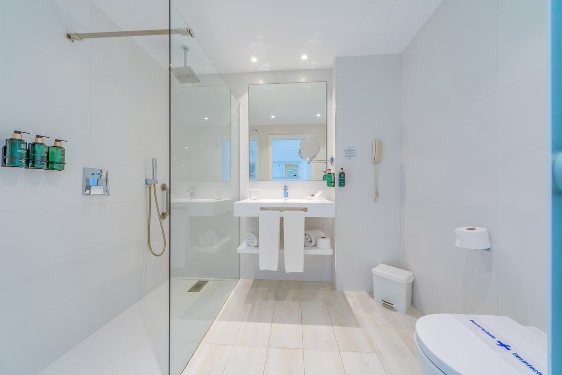 Baño moderno con ducha, lavabo y WC. Perfecto para tu Playa Esperanza Resort.