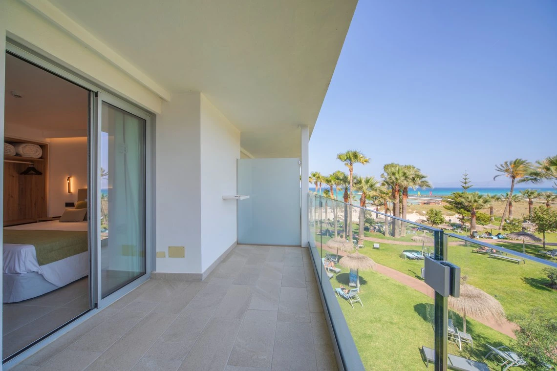 Terraza privada con vista al mar y palmeras, ideal para relajarse en Playa Esperanza Resort.