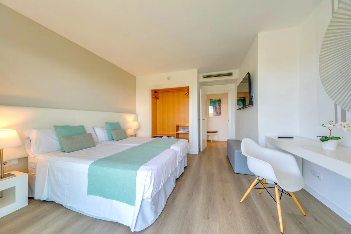 Habitación de hotel con cama grande, decoración moderna y escritorio. Playa Esperanza Resort