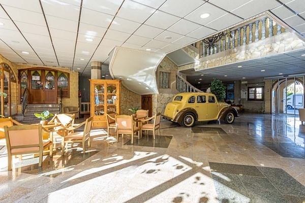 a yellow car is parked in the lobby of a building