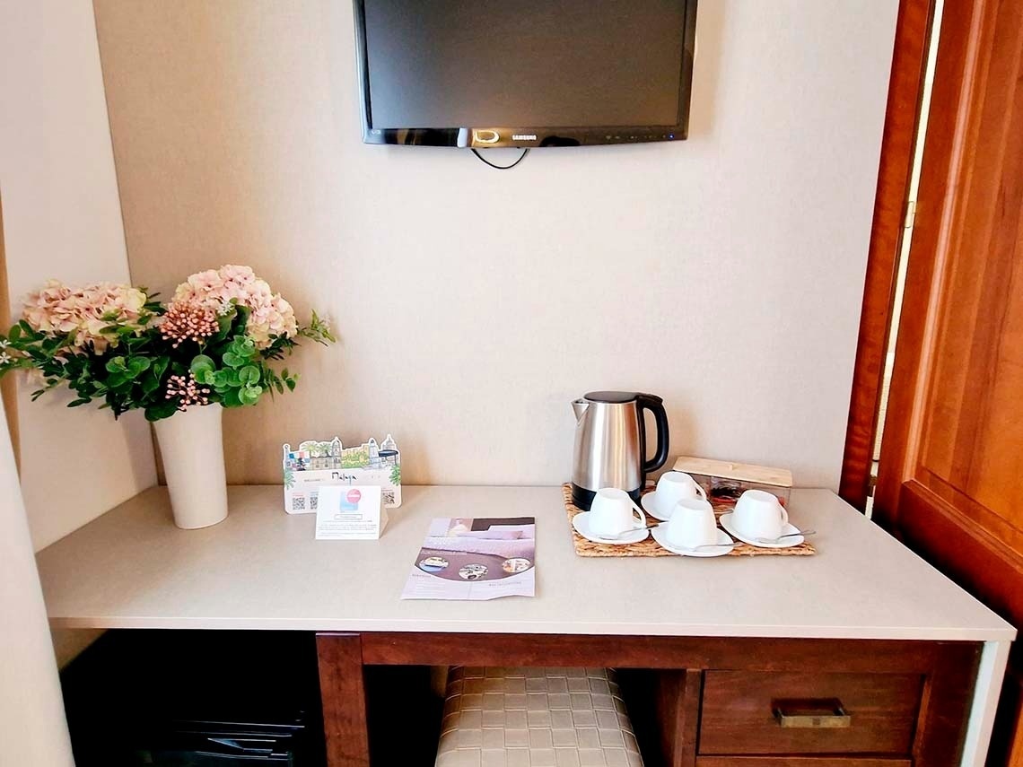 a desk with cups and a kettle on it