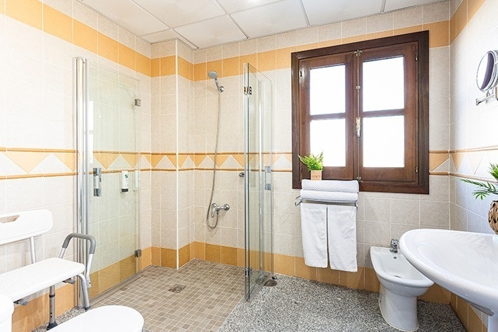 a bathroom with a walk in shower and a sink