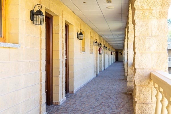 a long hallway with a fire extinguisher on the wall