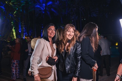 two women are posing for a picture in a dark room - 