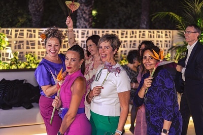 a group of women posing with flowers in their hands - 