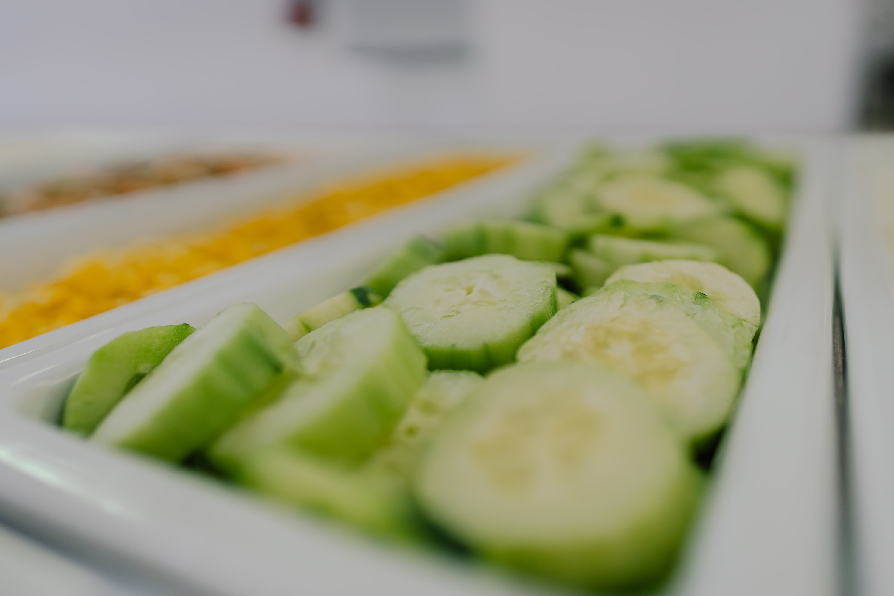 a tray of sliced cucumbers sits on a table