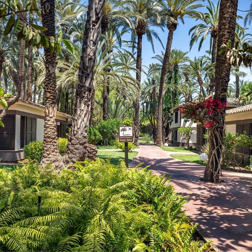 a sign in the middle of a lush green garden says 