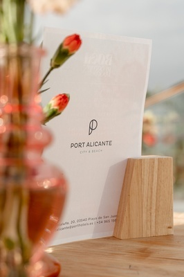 a sign for port alicante city & beach sits on a table - 