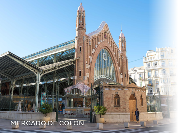 a woman is walking through a market with a sign that says ' mercado ' on it