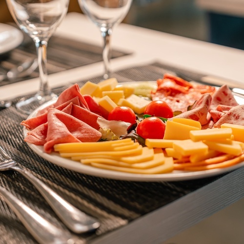 a plate of food on a table with wine glasses