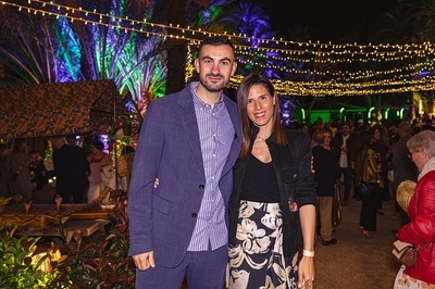 a man and a woman pose for a picture at a party - 