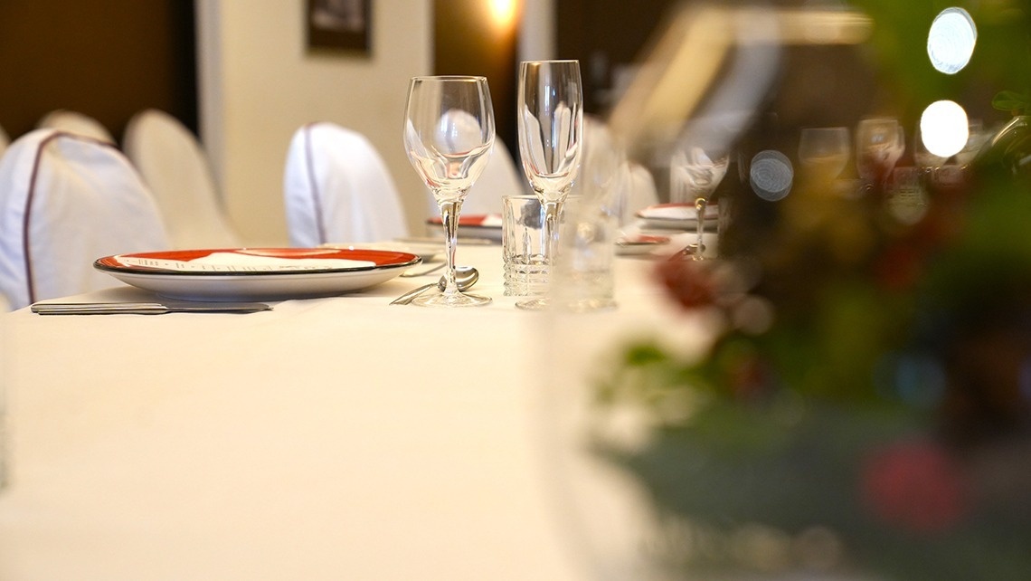 a long table with plates and glasses on it