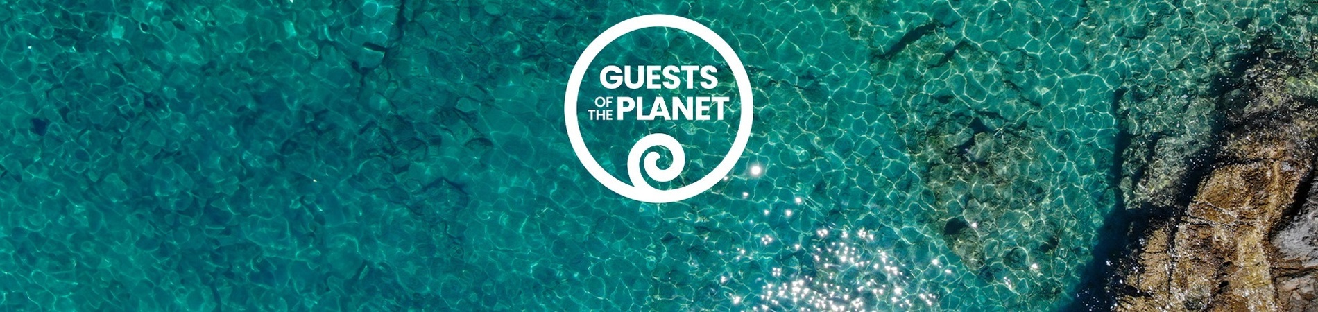 an aerial view of a body of water with a guests of the planet logo