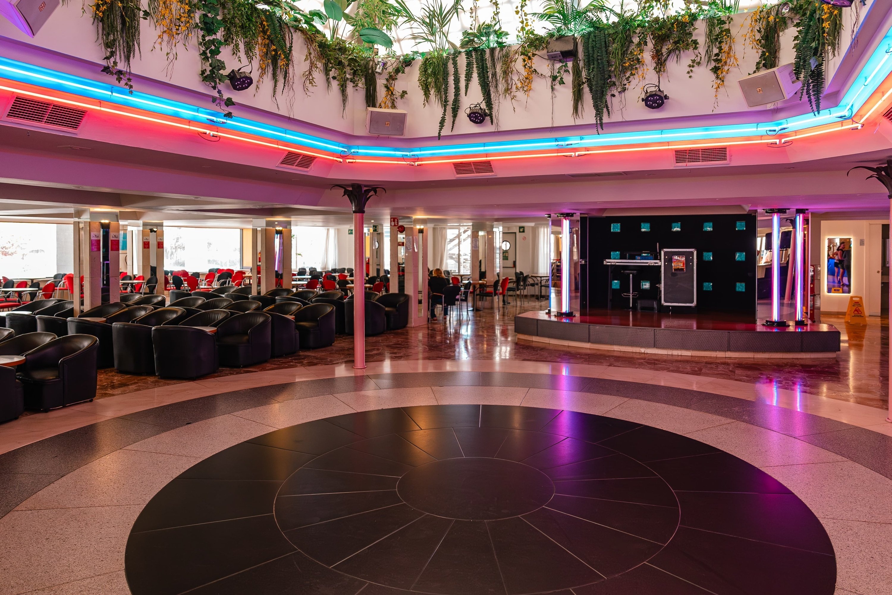 a large room with a dance floor and a dj