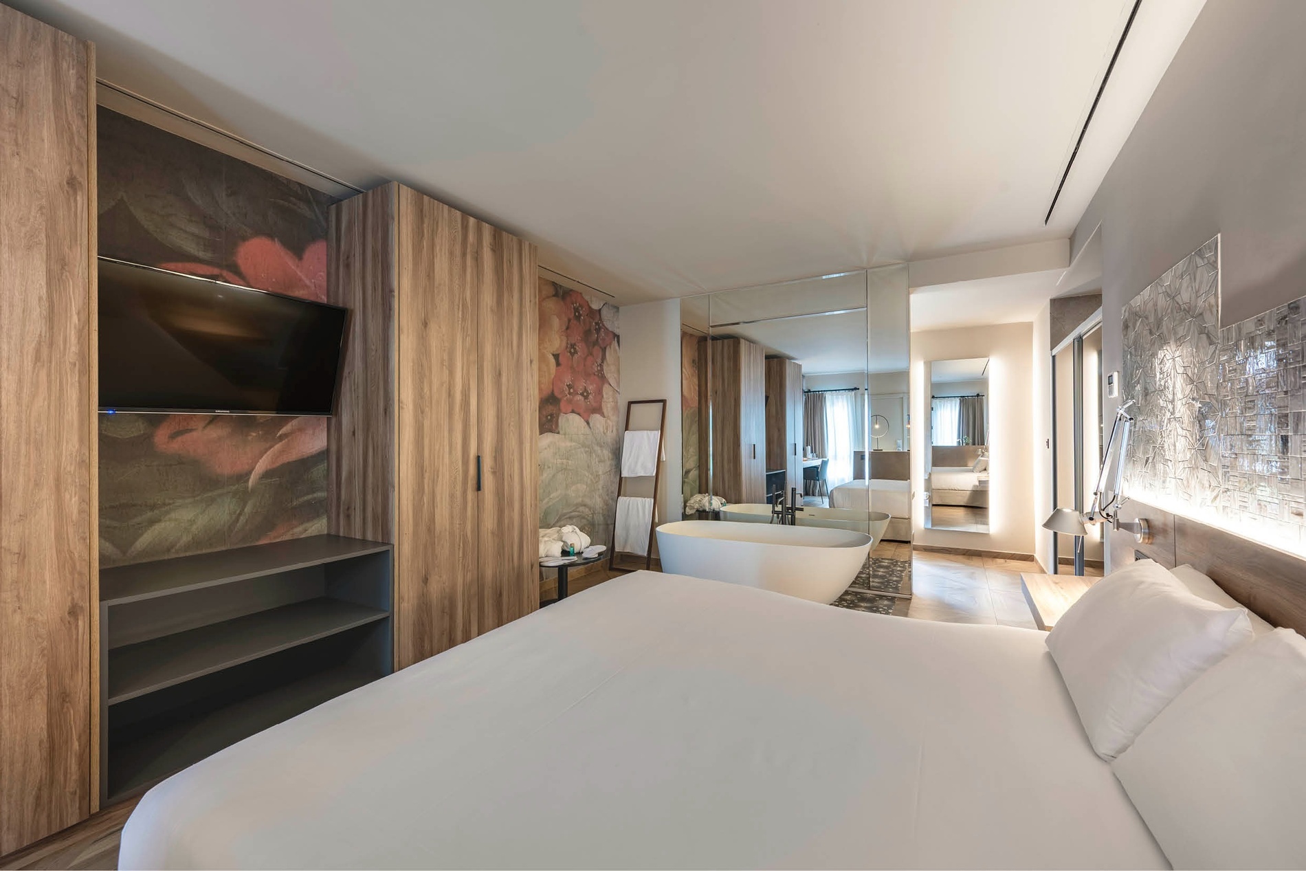 a hotel room with a large bed and a bathtub