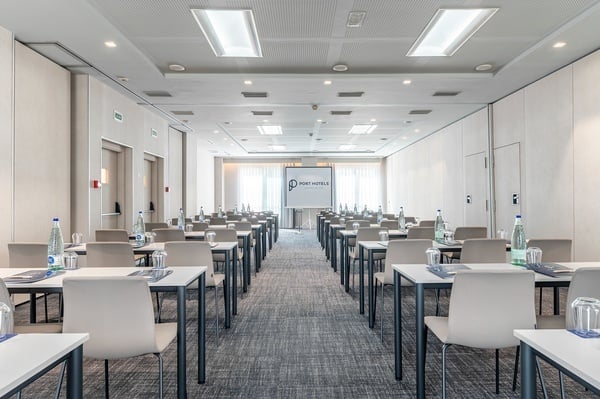 a conference room with tables and chairs set up for a port hotel meeting