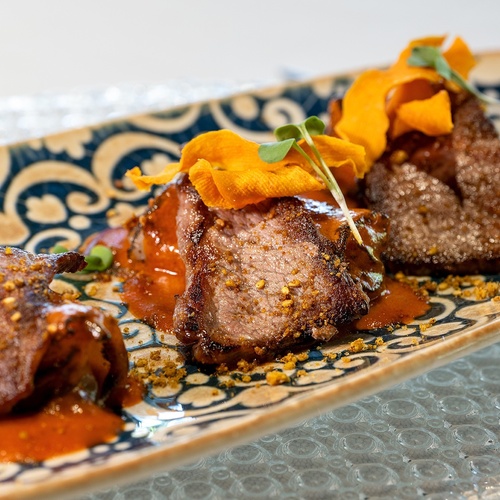 a plate of food with meat and sauce on it