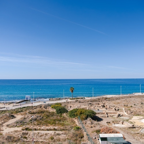 a view of the ocean from a fenced in area