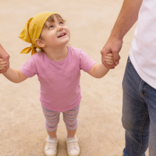 a person making a heart shape with their hands wearing a wristband that says 