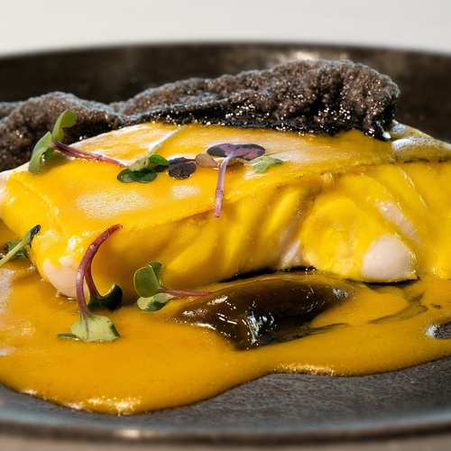 a close up of a plate of food with a yellow sauce