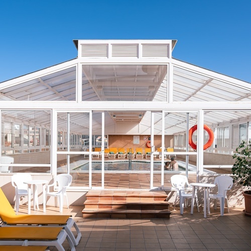 a swimming pool inside of a building with a life preserver