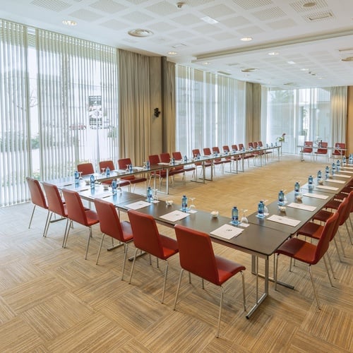 a conference room with tables and chairs set up in a u shape