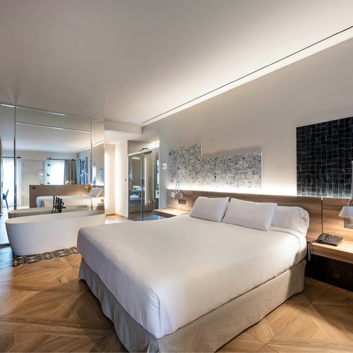 a hotel room with a large bed and a bathtub