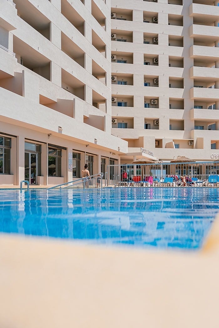 a large building with a swimming pool in front of it