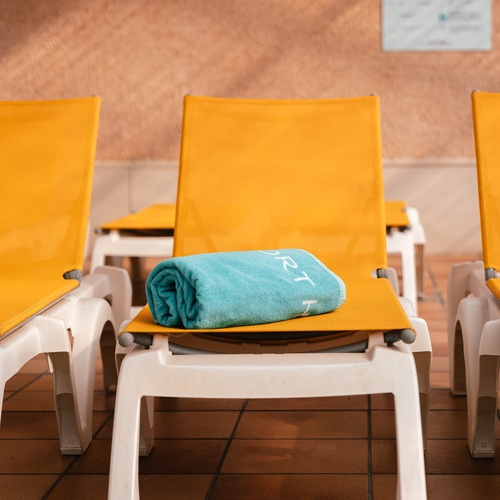 a blue towel on a yellow chair that says rt