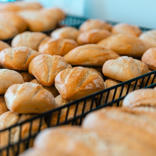 a bunch of rolls are sitting in a basket