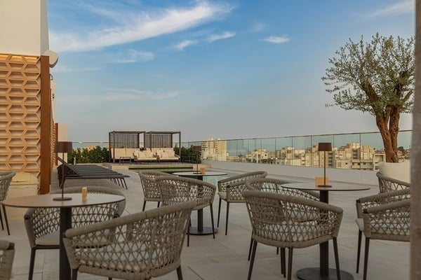 a group of people sitting at tables on a rooftop