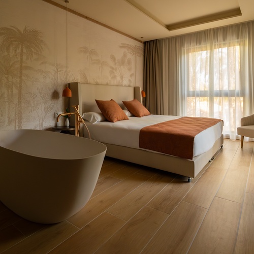 a hotel room with a bed and a bathtub