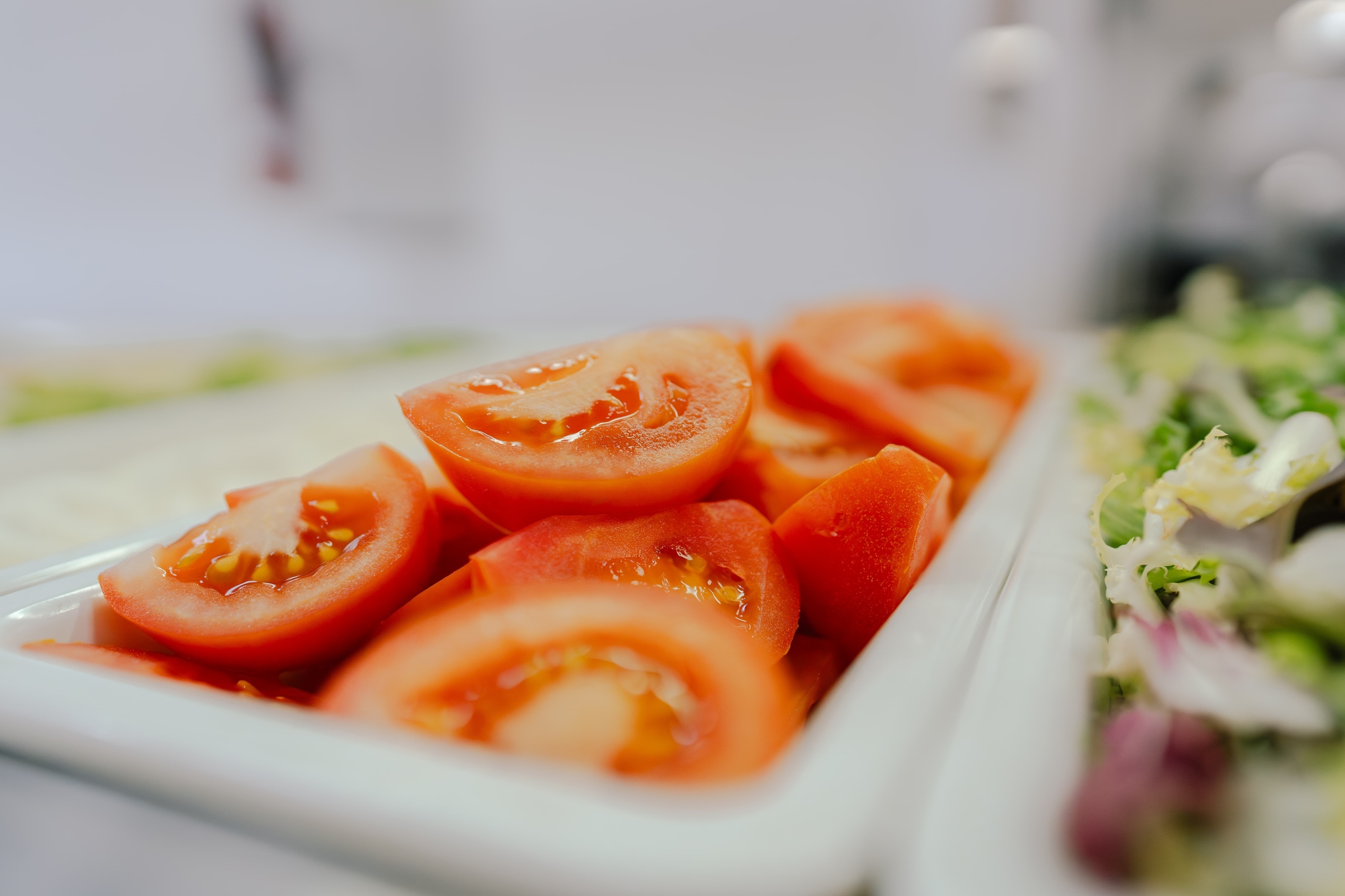 a tray of sliced tomatoes sits on a table