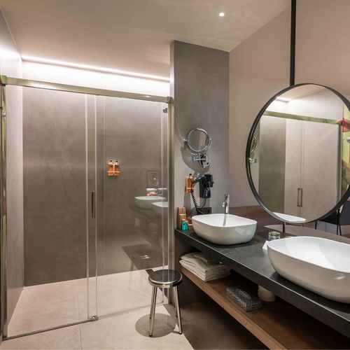 a bathroom with two sinks and a mirror