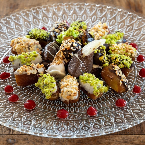 a glass plate with a variety of desserts on it