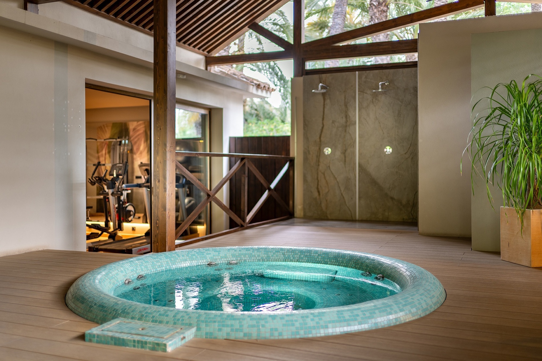 a jacuzzi in the middle of a room next to a gym