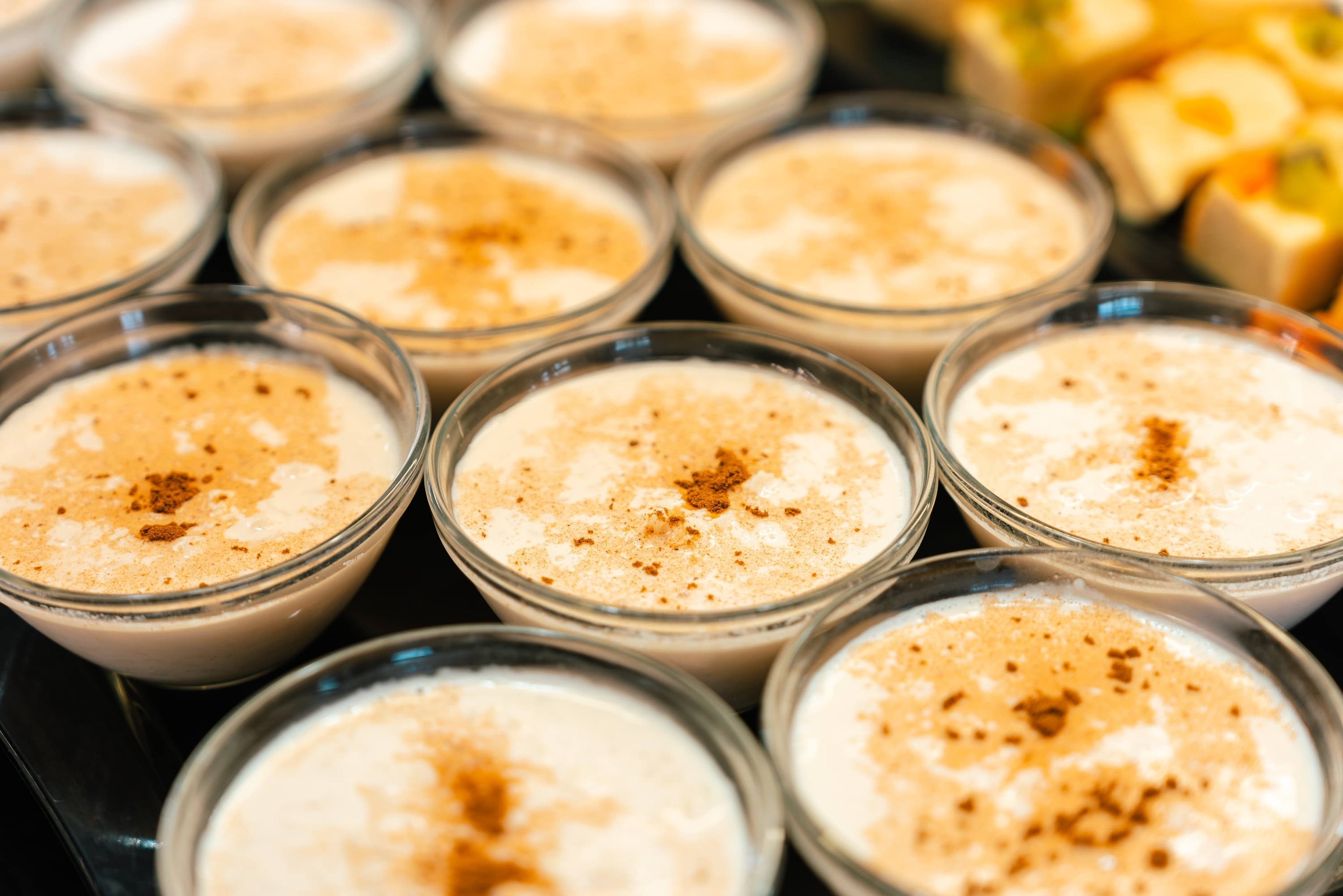 several bowls of pudding with cinnamon sprinkled on top