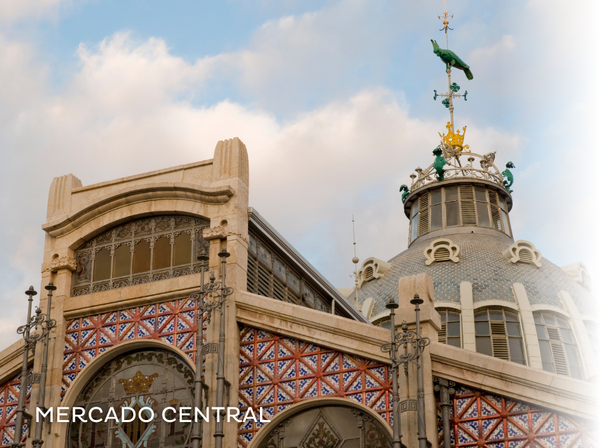 a woman is walking through a market with a sign that says ' mercado ' on it