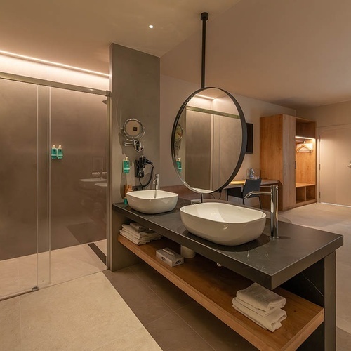 a bathroom with two sinks and a large mirror