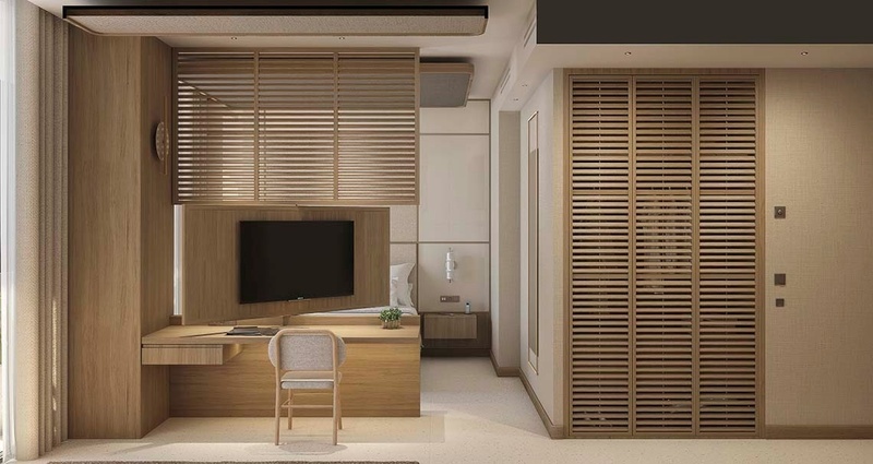 una habitación con un escritorio y una televisión en la pared