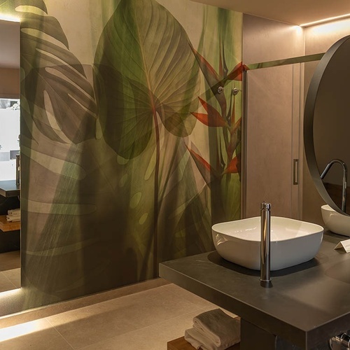 a bathroom with two sinks and a round mirror