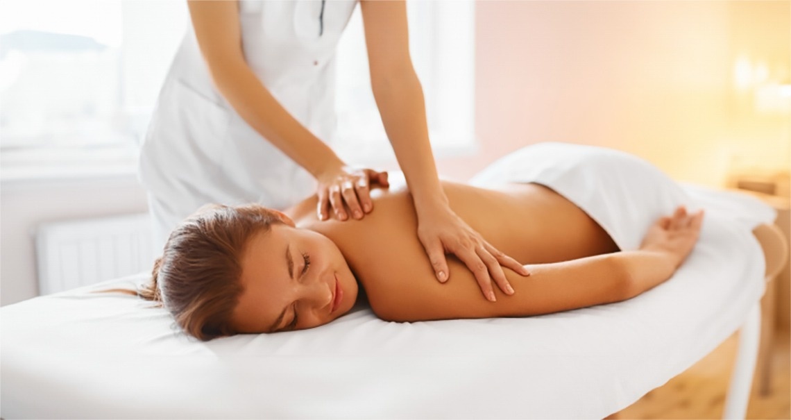 a woman is laying on a table getting a massage