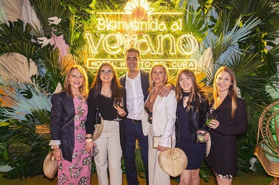 a group of people pose in front of a sign that says bienvenido al verano - 