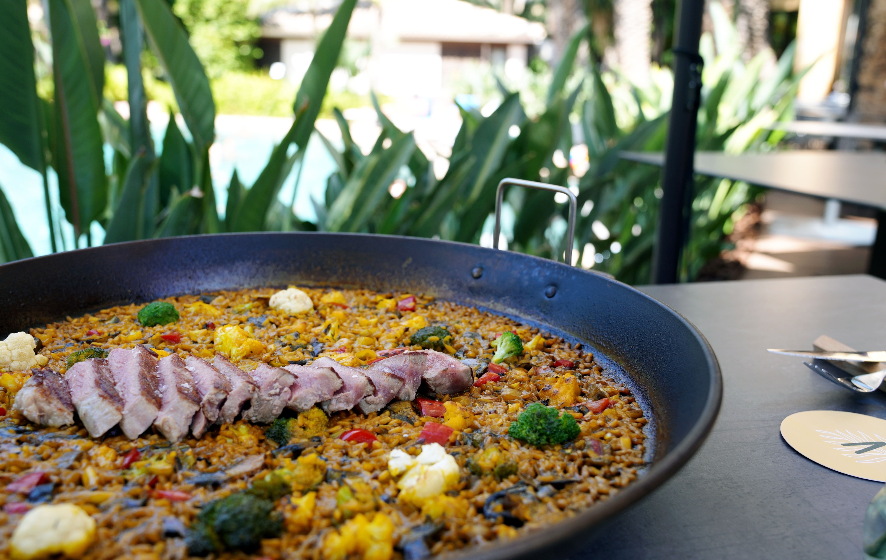 a pan of food with meat and vegetables on a table