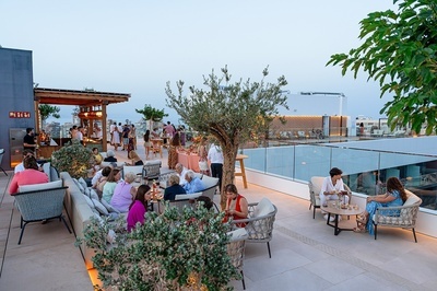 a group of people are gathered on a rooftop with a sign that says fire exit - 