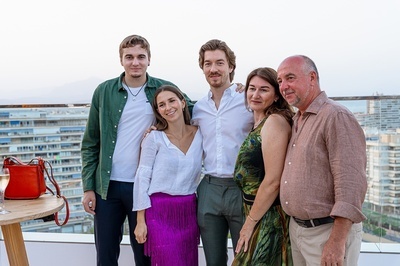 a group of people posing for a picture on a balcony - 